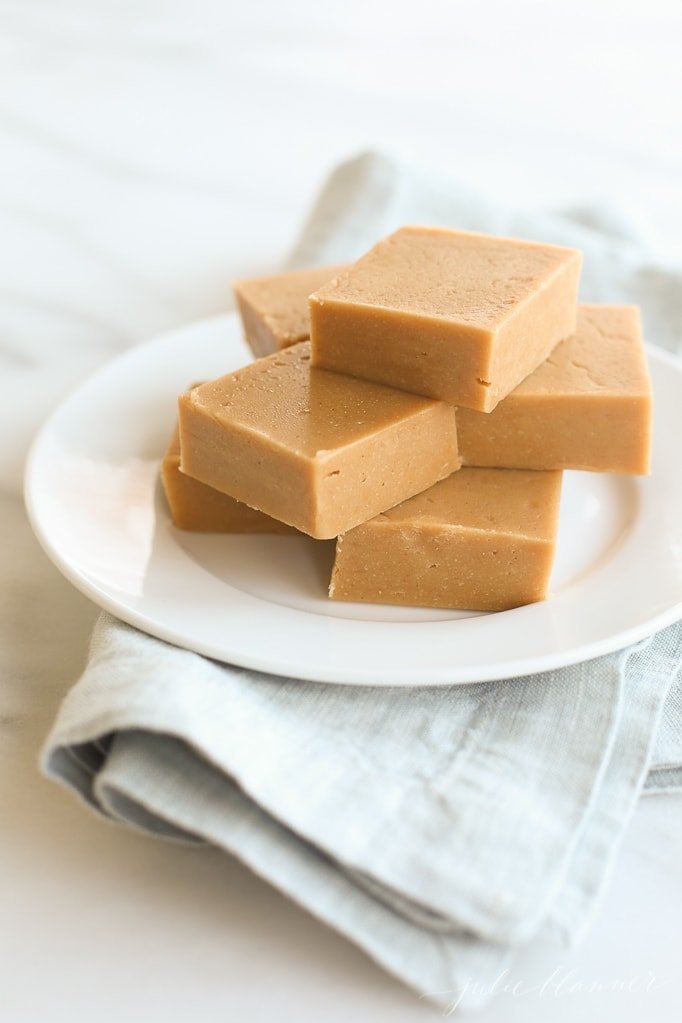 peanut butter fudge on a plate on top of blue napkin