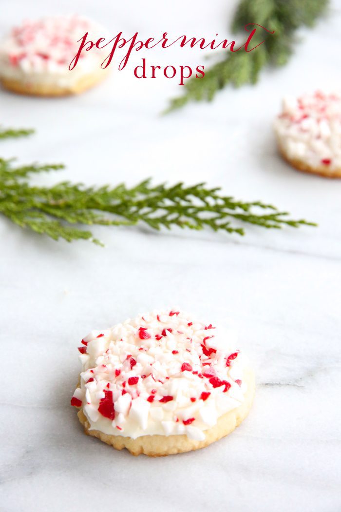 peppermint cookies on marble countertop with holly leaves with text overlay