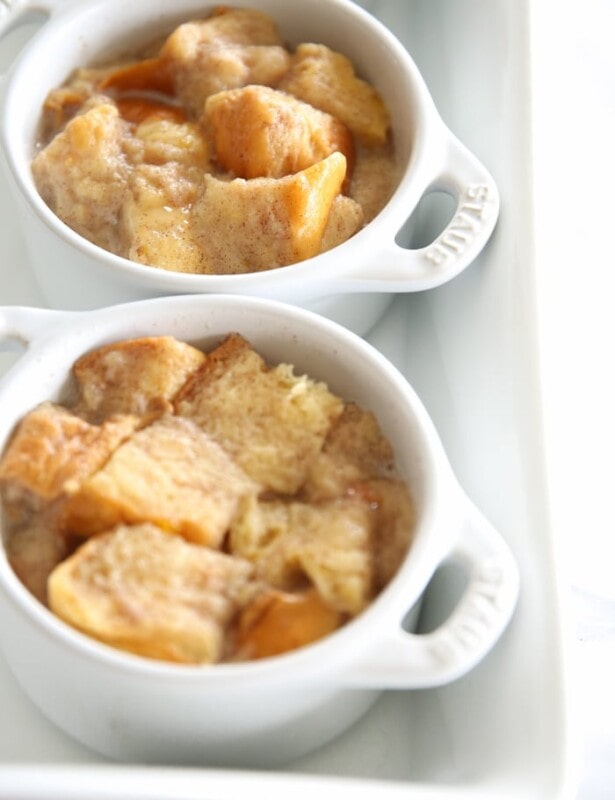 custard bread pudding in two white individual baking dishes