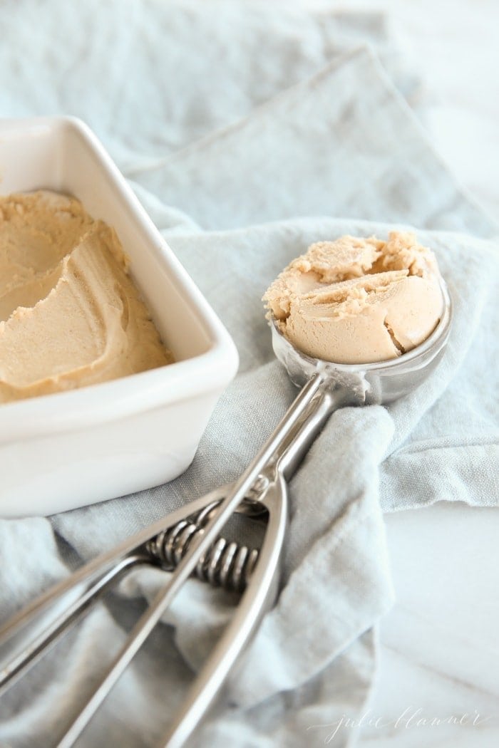 scoop of peanut butter ice cream next to ceramic dish