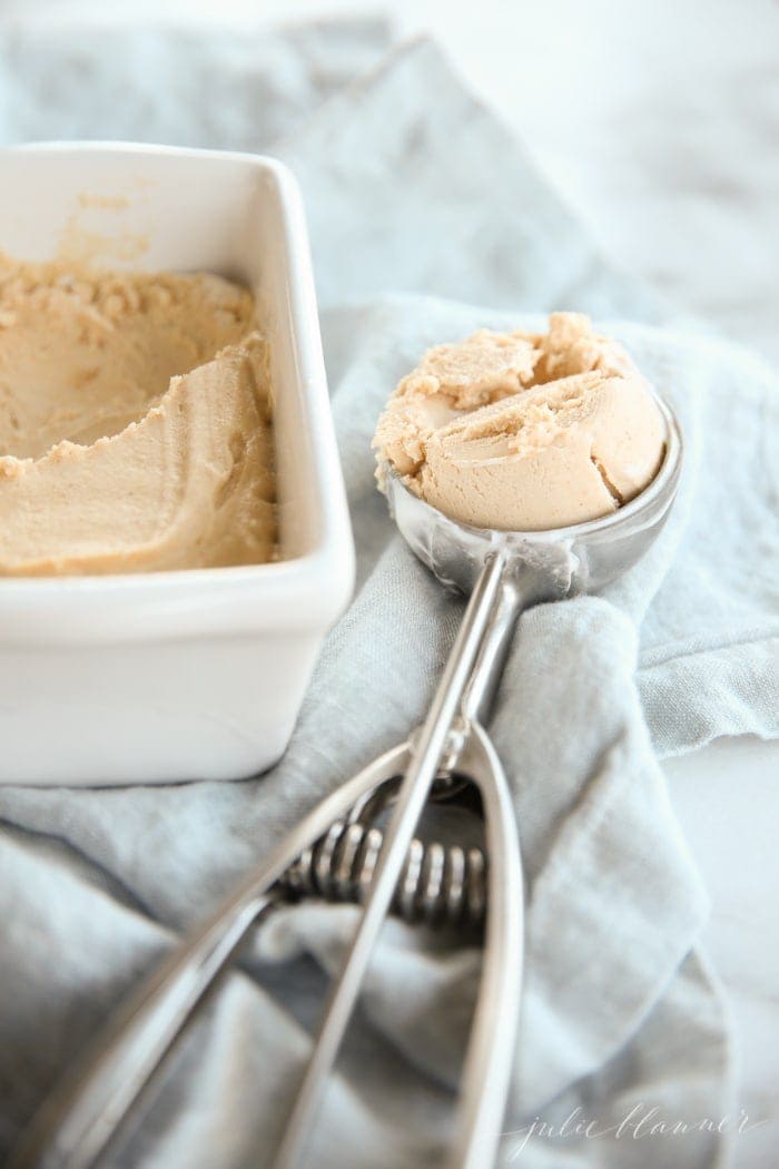 No churn peanut butter ice cream in a loaf pan and ice cream scoop