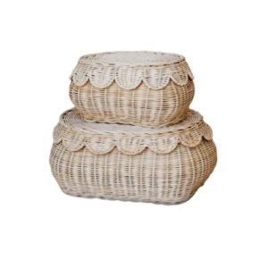 Two wicker baskets with scalloped-edged lids are stacked, one atop the other, against a plain white background—perfect for adding charm and storage to your linen closet.