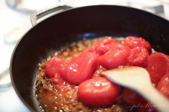 Tomatoes added to the pan