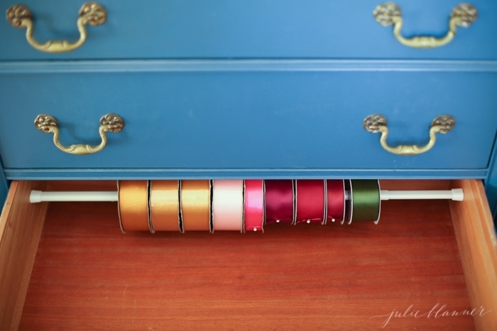 An organized craft drawer full of organized ribbon and more desk organization ideas.