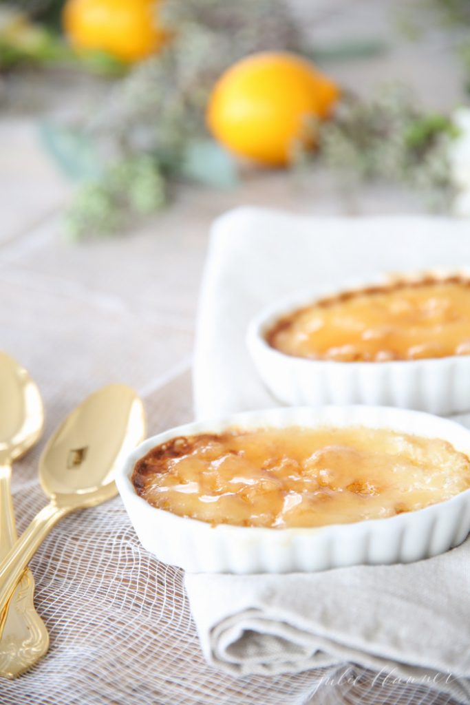 Creme brulee in two white ramekins with spoons