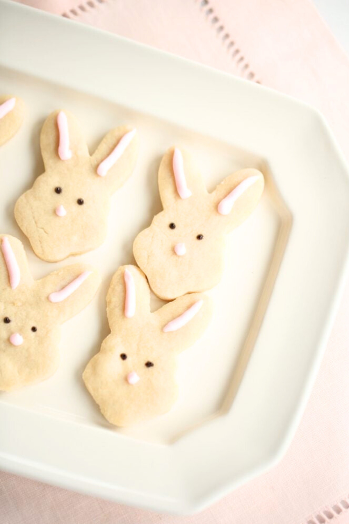 easter shortbread cookies shaped like bunnies on a white platter