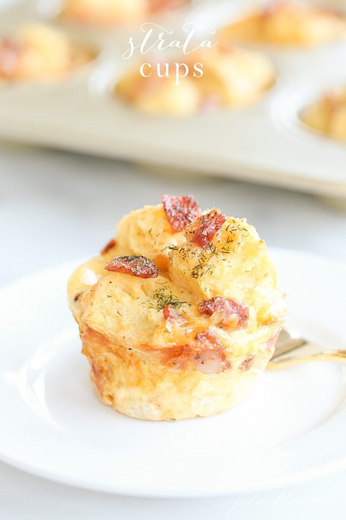 This perfectly portioned egg strata recipe is easy to make, serve and enjoy! Make these beautiful breakfast bites ahead or just before guests arrive. egg strata on a white plate with muffin tin and text overlay
