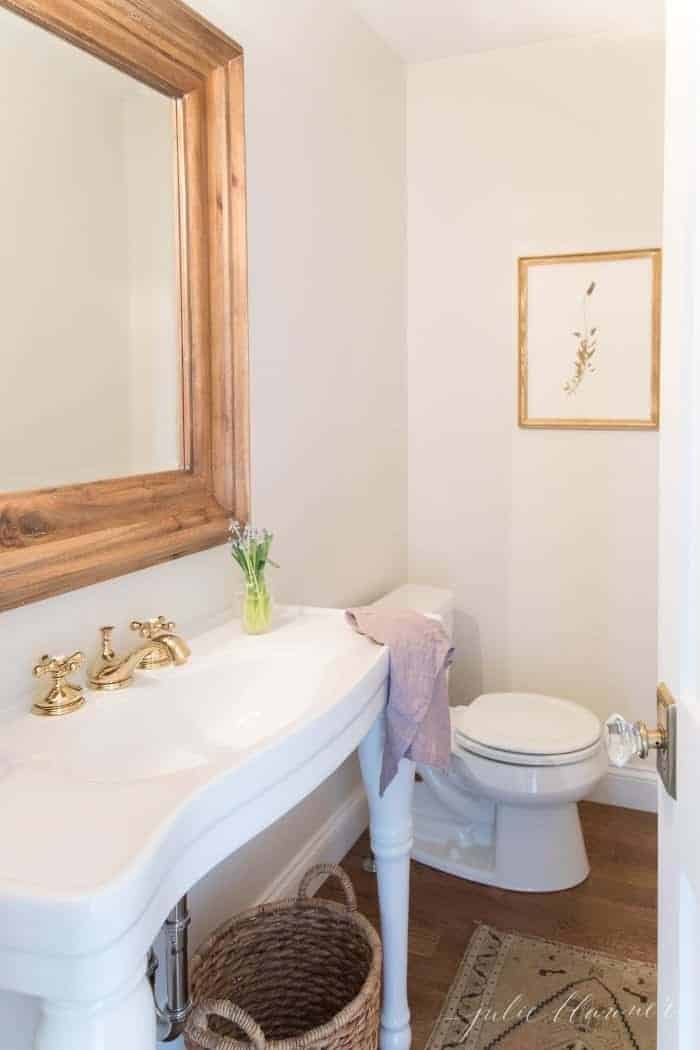 traditional bathroom with parisian sink and wood mirror