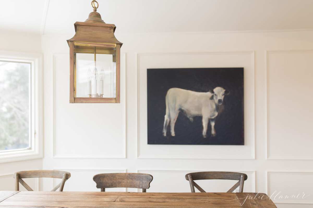cow painting over breakfast nook table