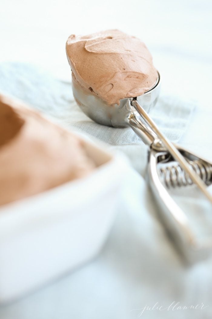 The chocolate ice cream in a silver scoop