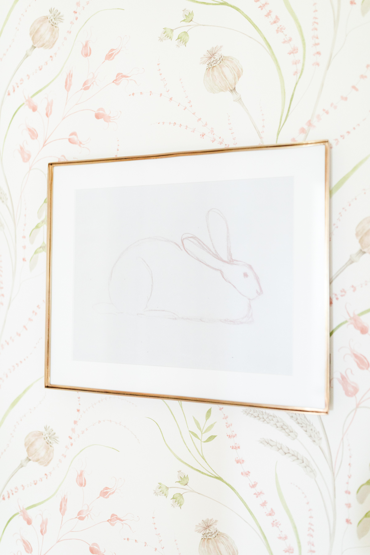 Bunny sketch art on a wallpapered wall.