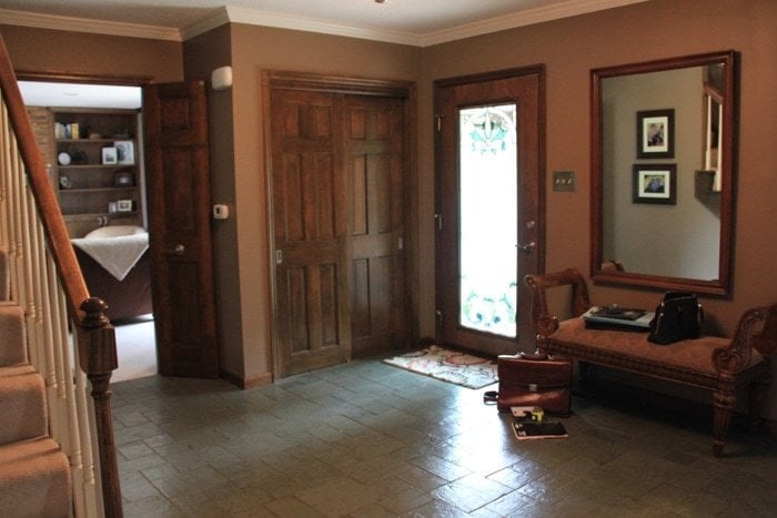 A dark entryway in the before photo for a home's before and after makeover