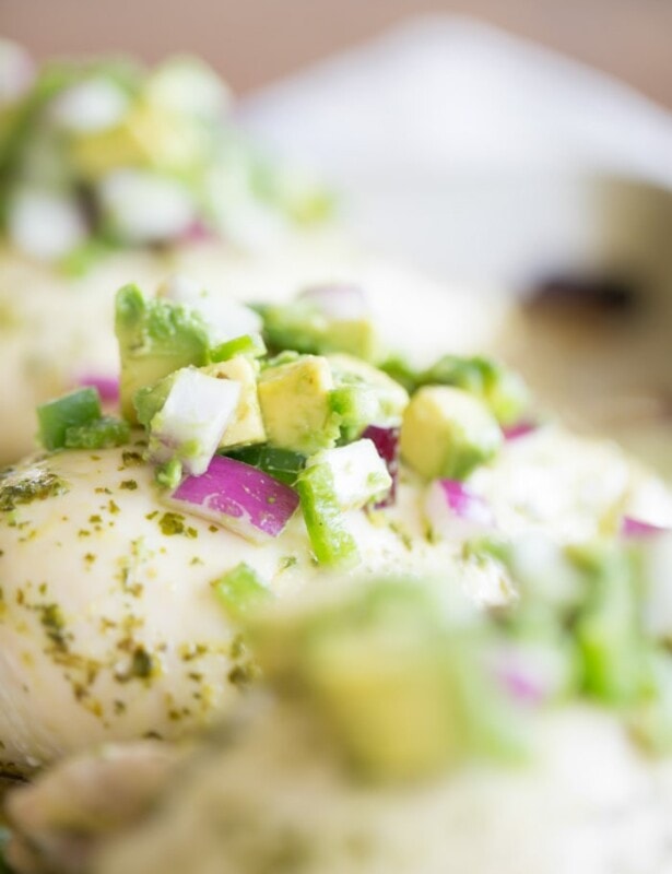 chunky pico de gallo with avocado on baked chicken breasts