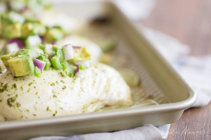 healthy cilantro lime chicken with avocado salsa on baking sheet