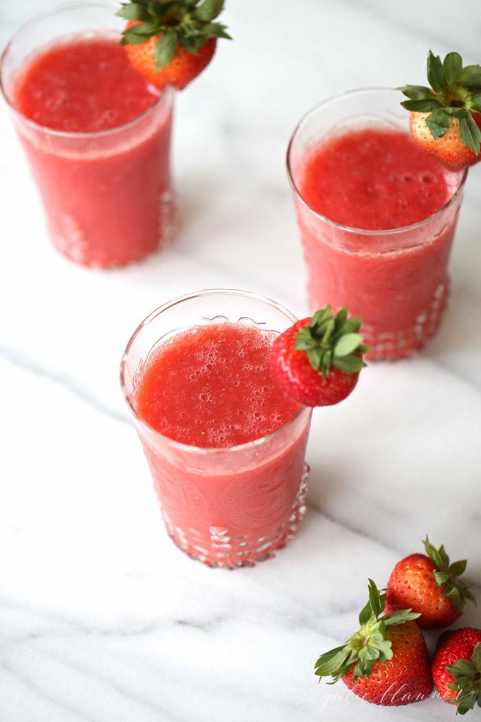 Champagne Slushies in tall glasses with garnish