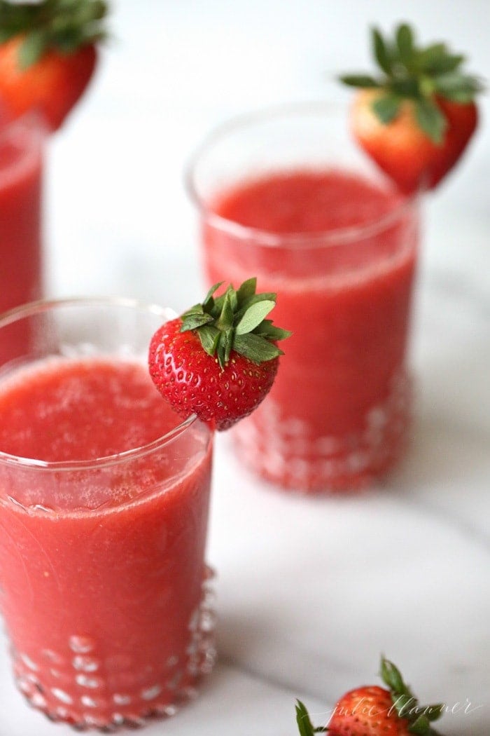 Frozen champagne cocktails with strawberry garnish