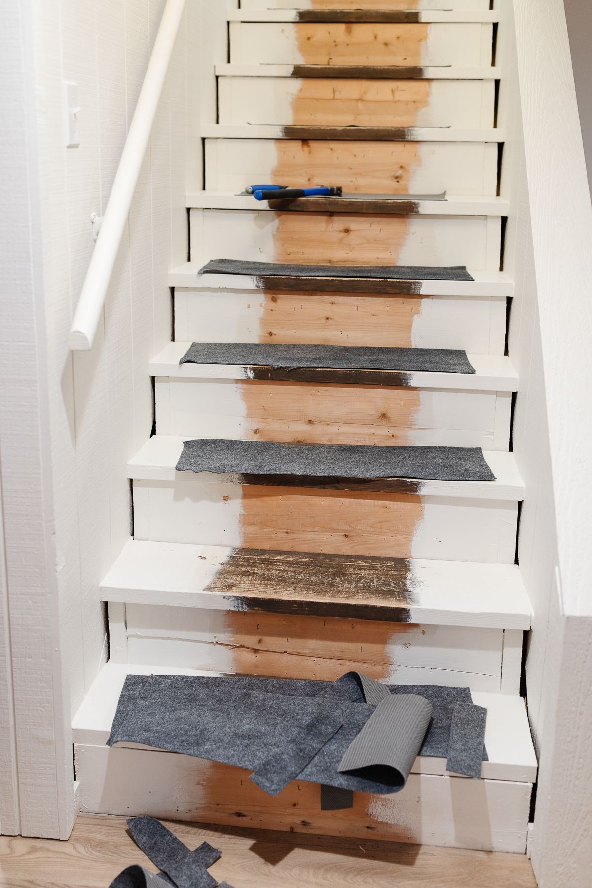 A diy staircase makeover before a stair runner goes down
