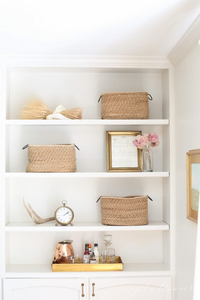 bookcase decorated with wheat and antlers for fall