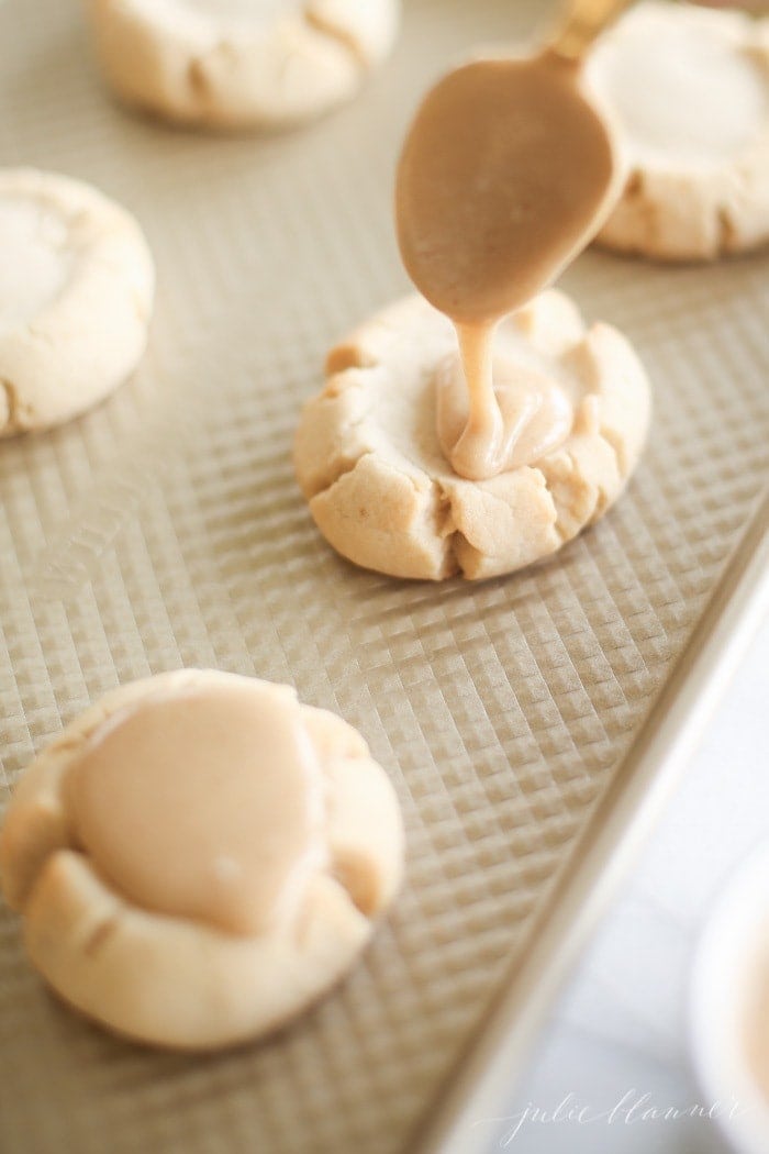 Spooning the icing on to the cookies