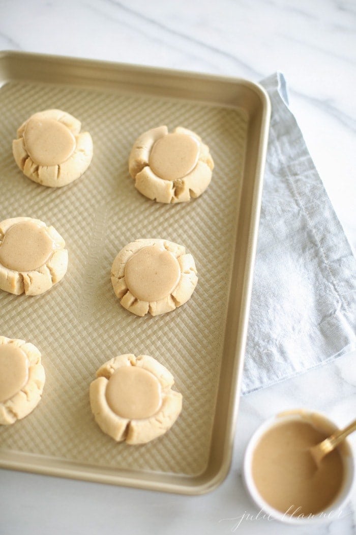 Salted Caramel iced sugar cookies on a baking sheet ready to eat