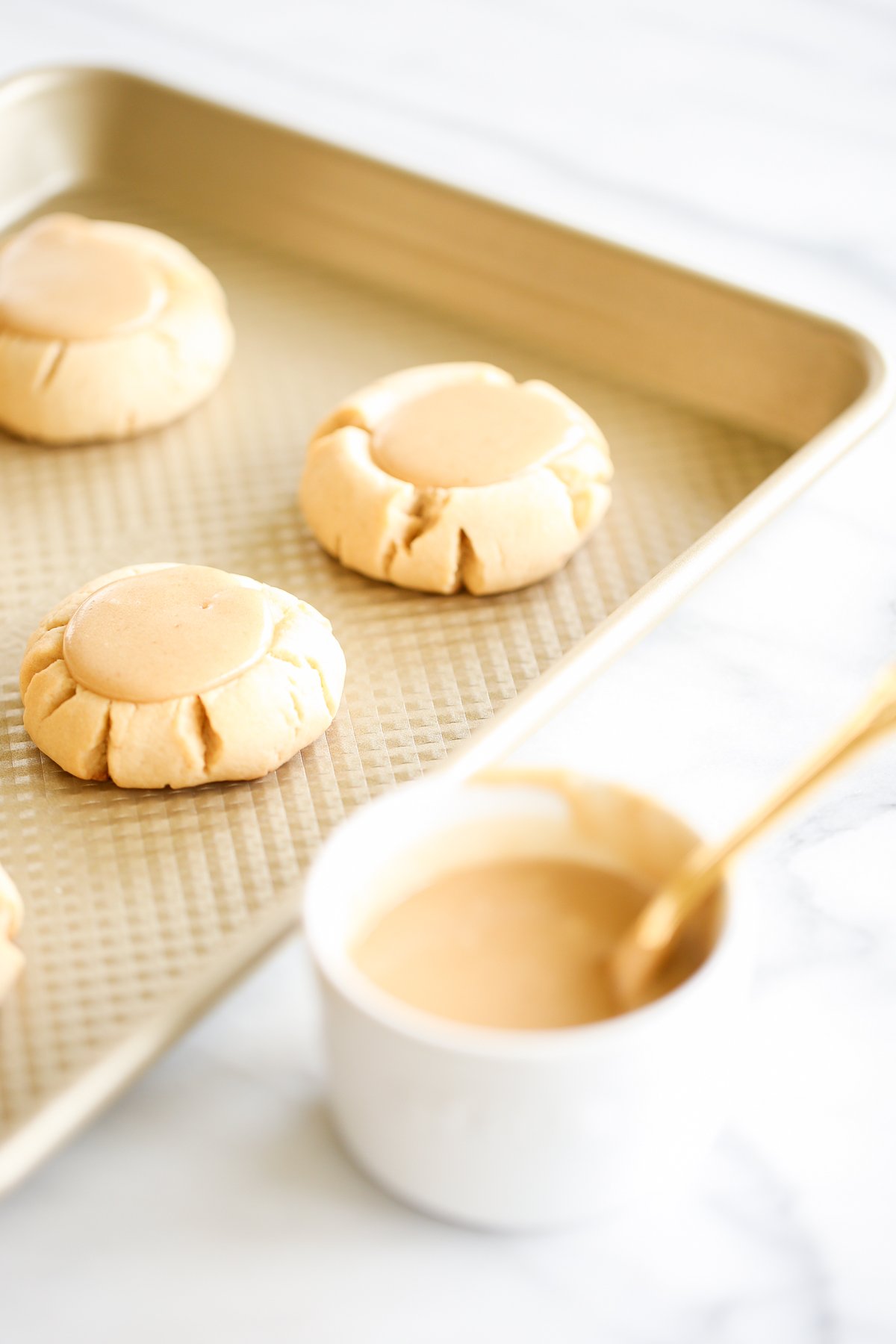 Caramel peanut butter cookies on a baking sheet.