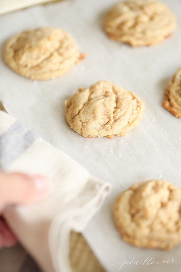Oatmeal brickle cookies on a tray with parchment