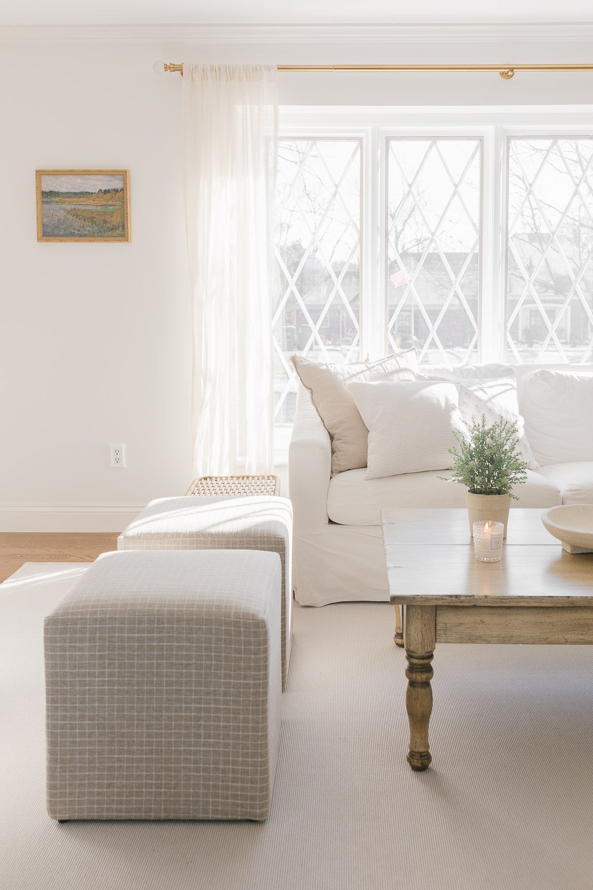 A white living room with walls painted in a neutral paint color, SW Zurich White