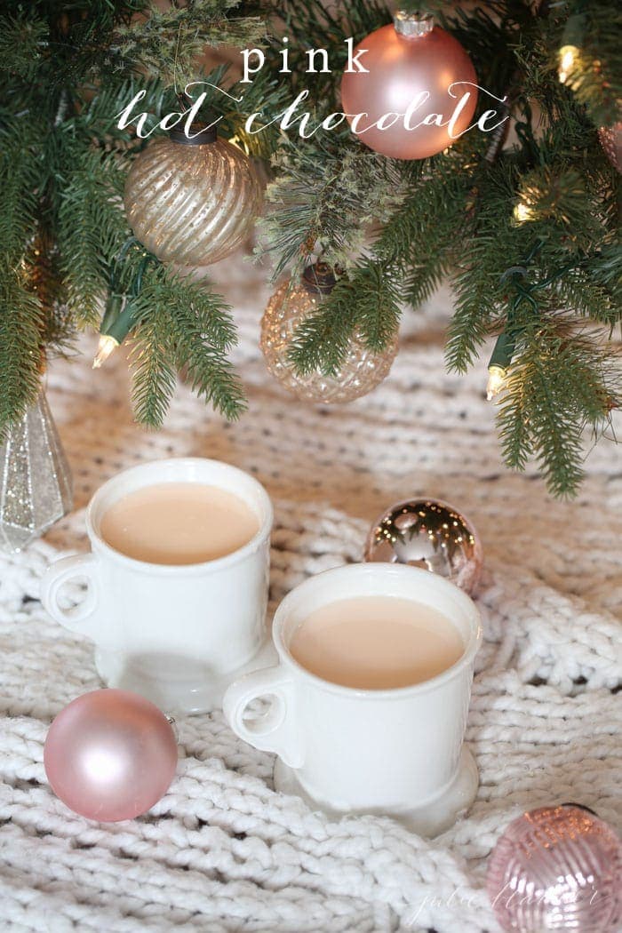 Two mugs of pink hot chocolate with text overlay