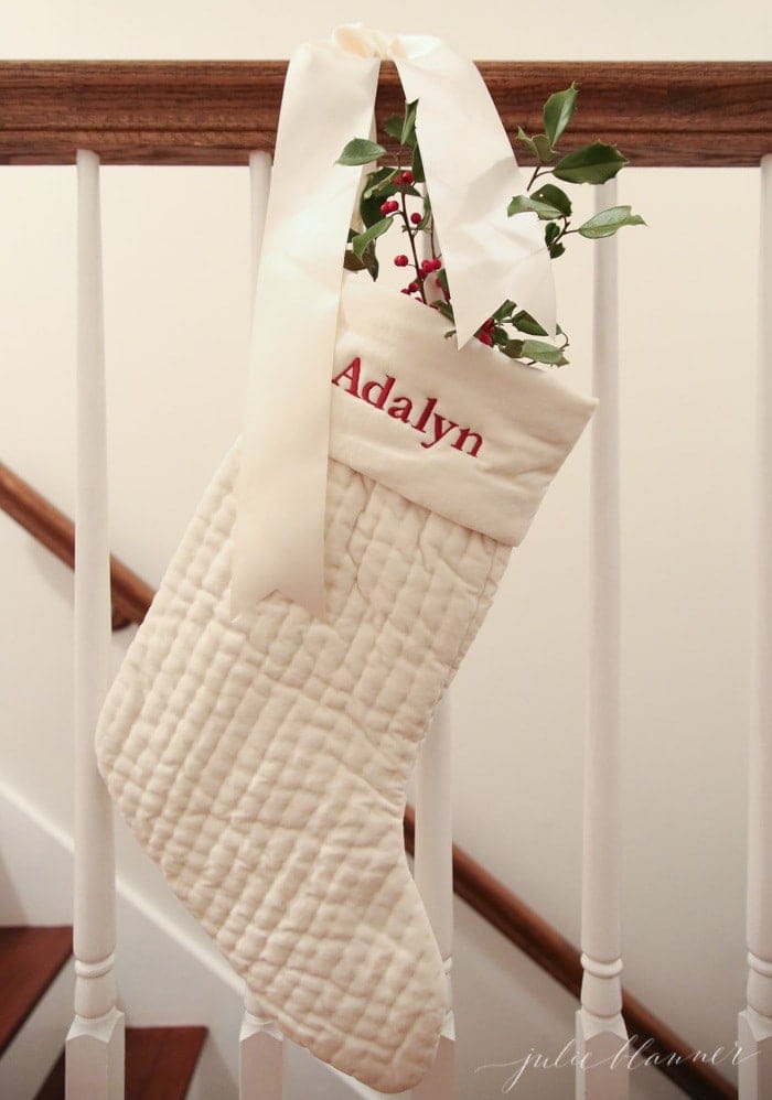 festive Christmas decorations | ivory stockings filled with holly