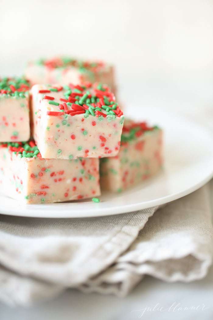 A stack of white chocolate fudge with sprinkles on plate