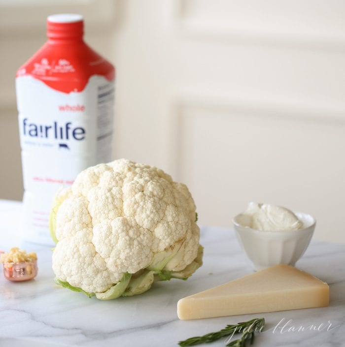 Fairlife milk, cauliflower, cream cheese, parmesan, and rosemary on a marble countertop