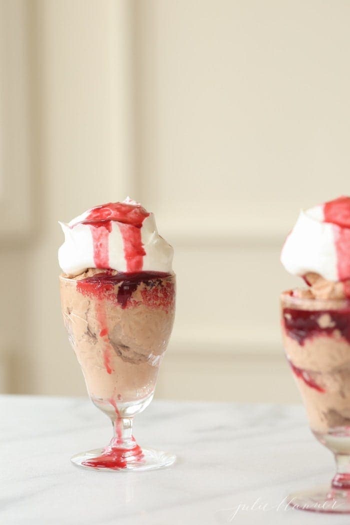 Raspberry sauce served on top of a glass of chocolate mousse and cream