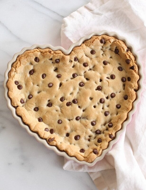 chocolate chip cookie cake in a heart shaped tart pan