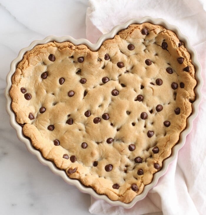 chocolate chip cookie cake in a heart shaped tart pan