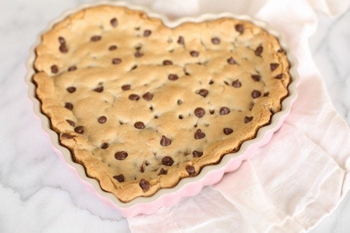 chocolate chip cookie cake in a heart shaped tart pan