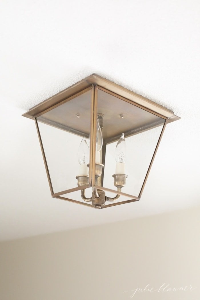 Looking for an elegant way to light up your hallway? Brass mini lanterns are what you need! Timeless, classic, beautiful they gracefully and add character. Closeup of a mini brass lantern