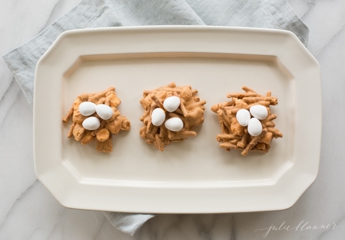 Butterscotch and peanut butter birds nest cookies on a white platter.