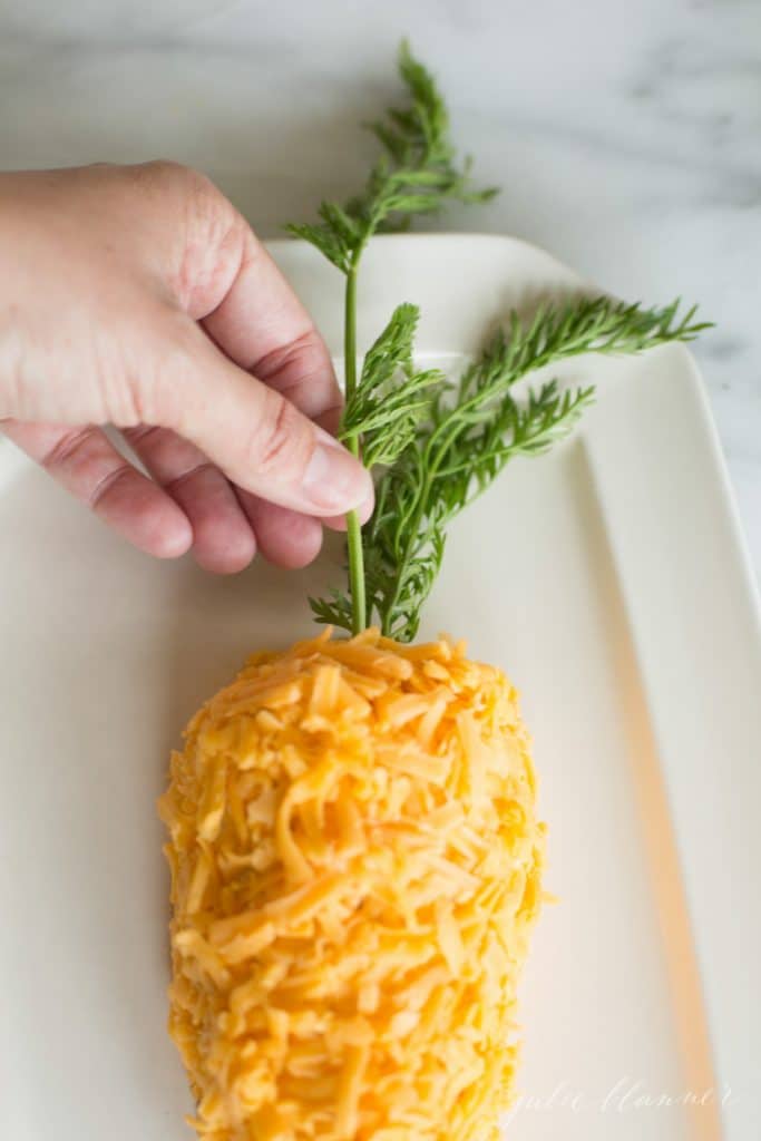 Adding the carrot stem to the cheese ball