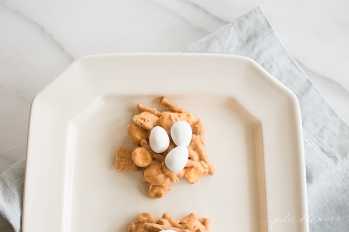 Butterscotch and peanut butter birds nest cookies on a white platter.