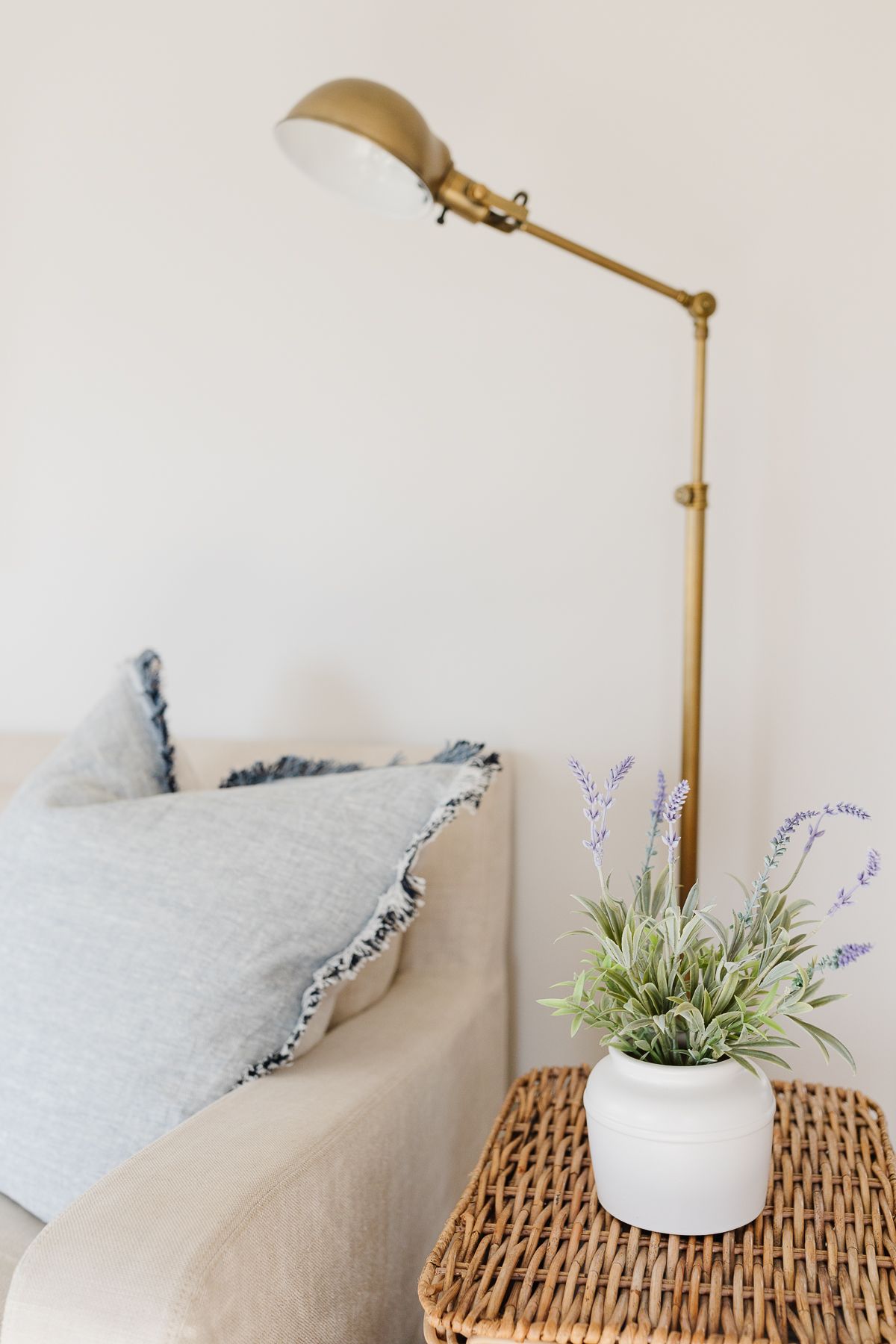 A living room with faux potted lavender on a stack of baskets