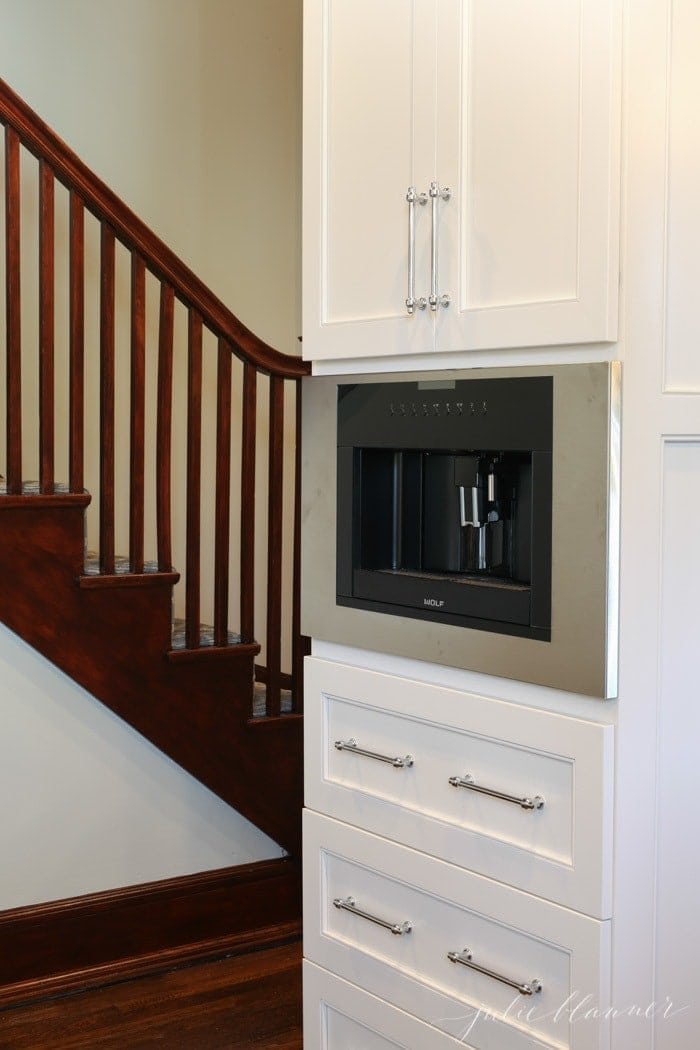 build in coffee maker in a new white kitchen of a historic home