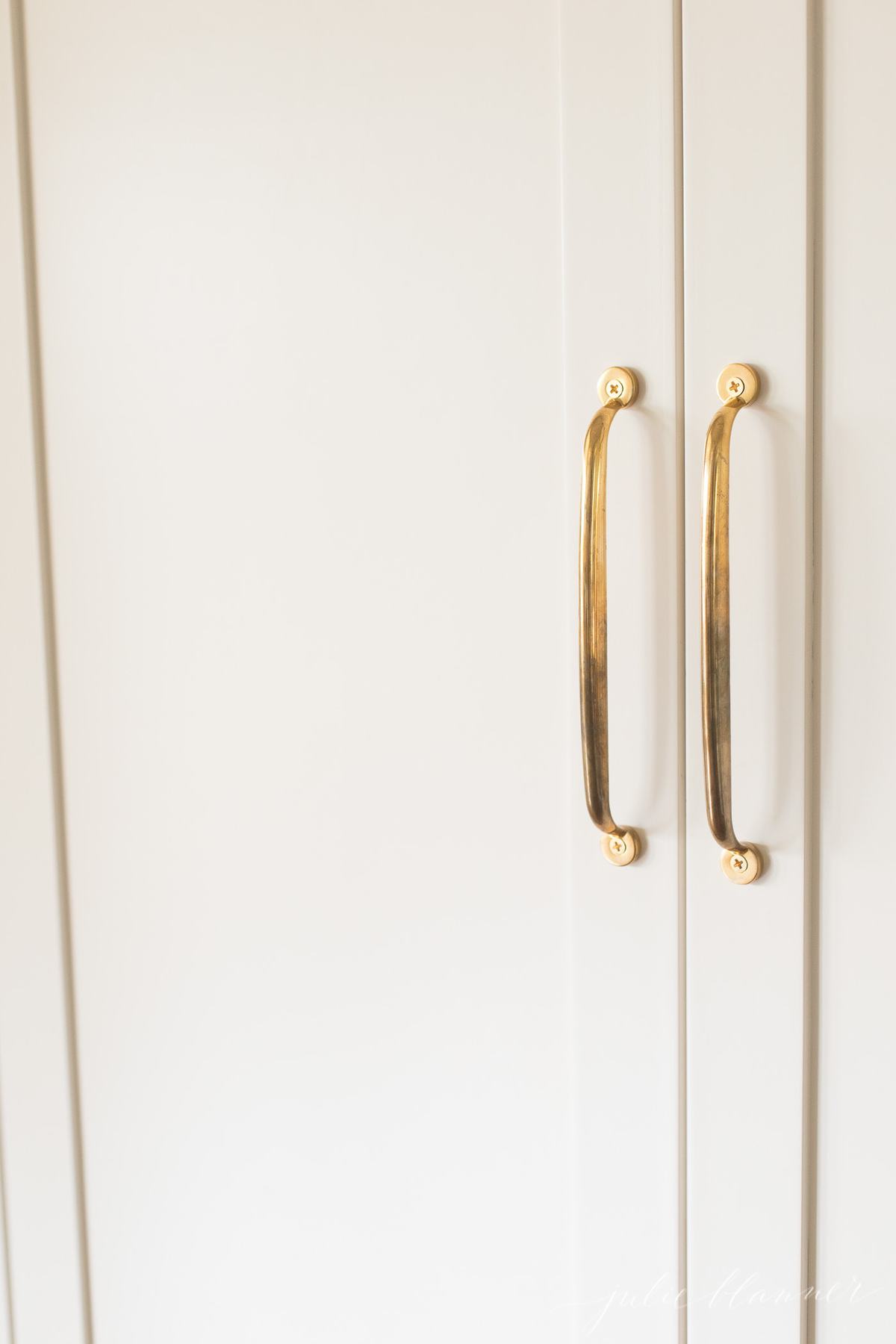 Brass appliance without pull layer on walled refrigerator.