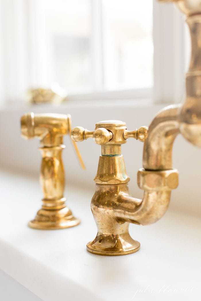 unlacquered brass faucet in a classic kitchen design