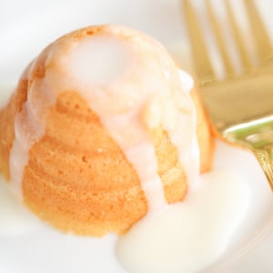 A honey lemon cake on a plate with a fork.