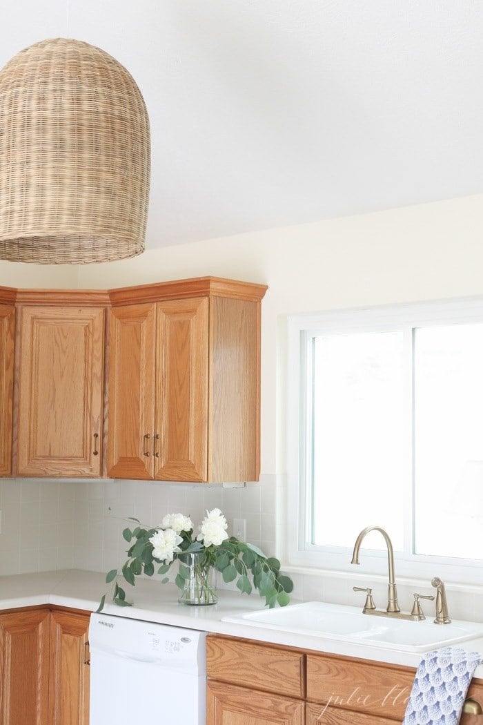 oak overlay cabinets in kitchen with pendant light