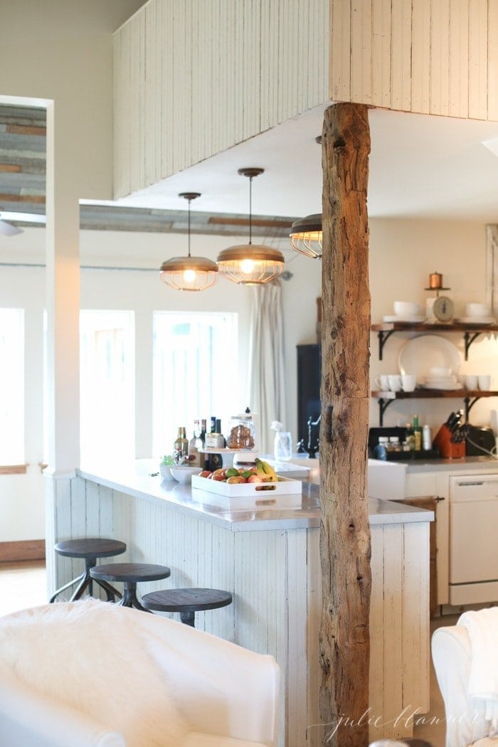 A farmhouse kitchen filled with rustic wooden elements and industrial farmhouse interior design touches.
