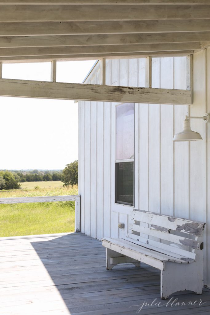 white board and batten barn with wood floors and barn light