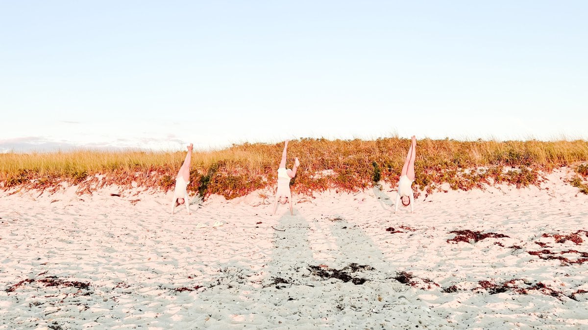 Three little girls doing handstands on a beach on Martha's Vineyard