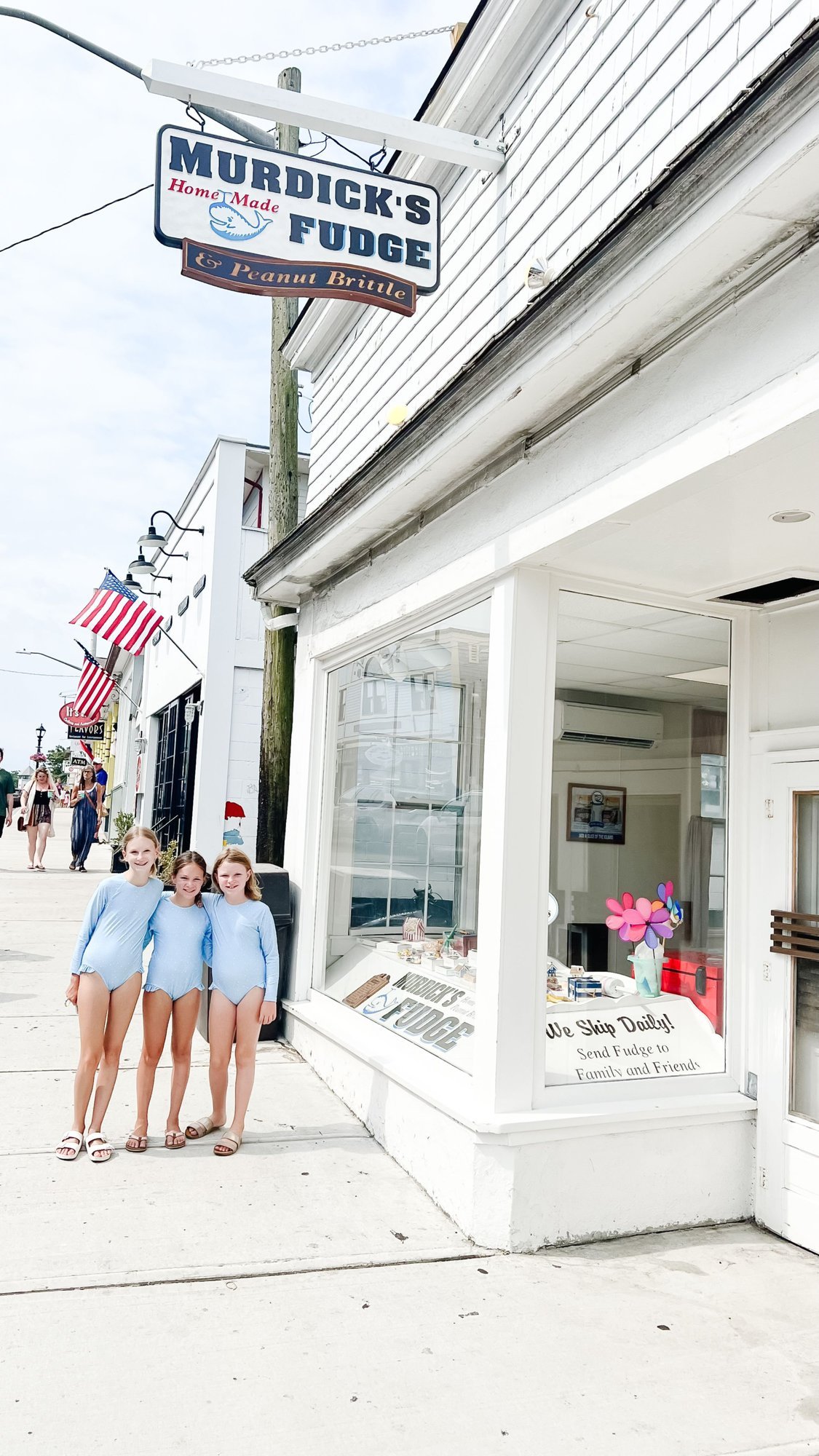 Three little girls standing in front of Murdock's Fudge in Martha's Vineyard