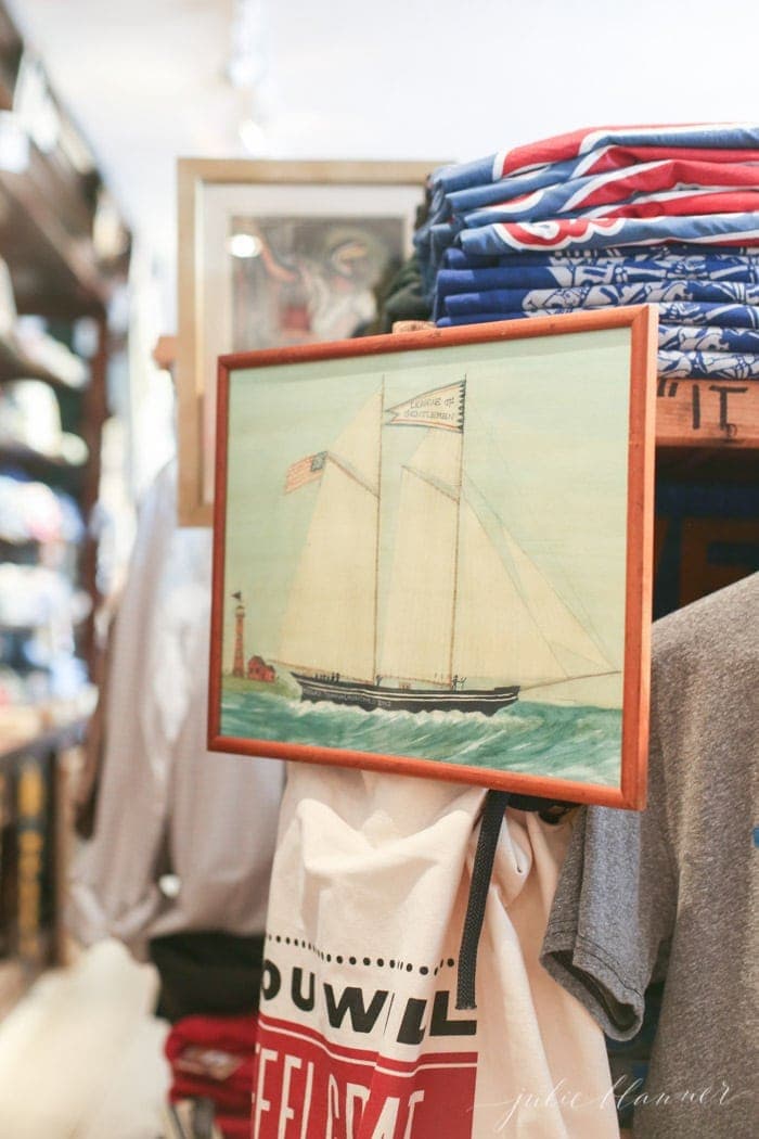 Martha's Vineyard retail store, with t shirts in the background and vintage art for sale.